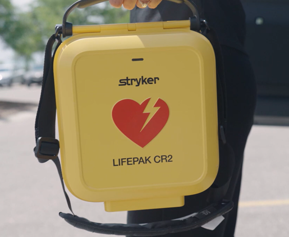 LIFEPAK CR2 TOUGHCase Yellow being carried outdoors
