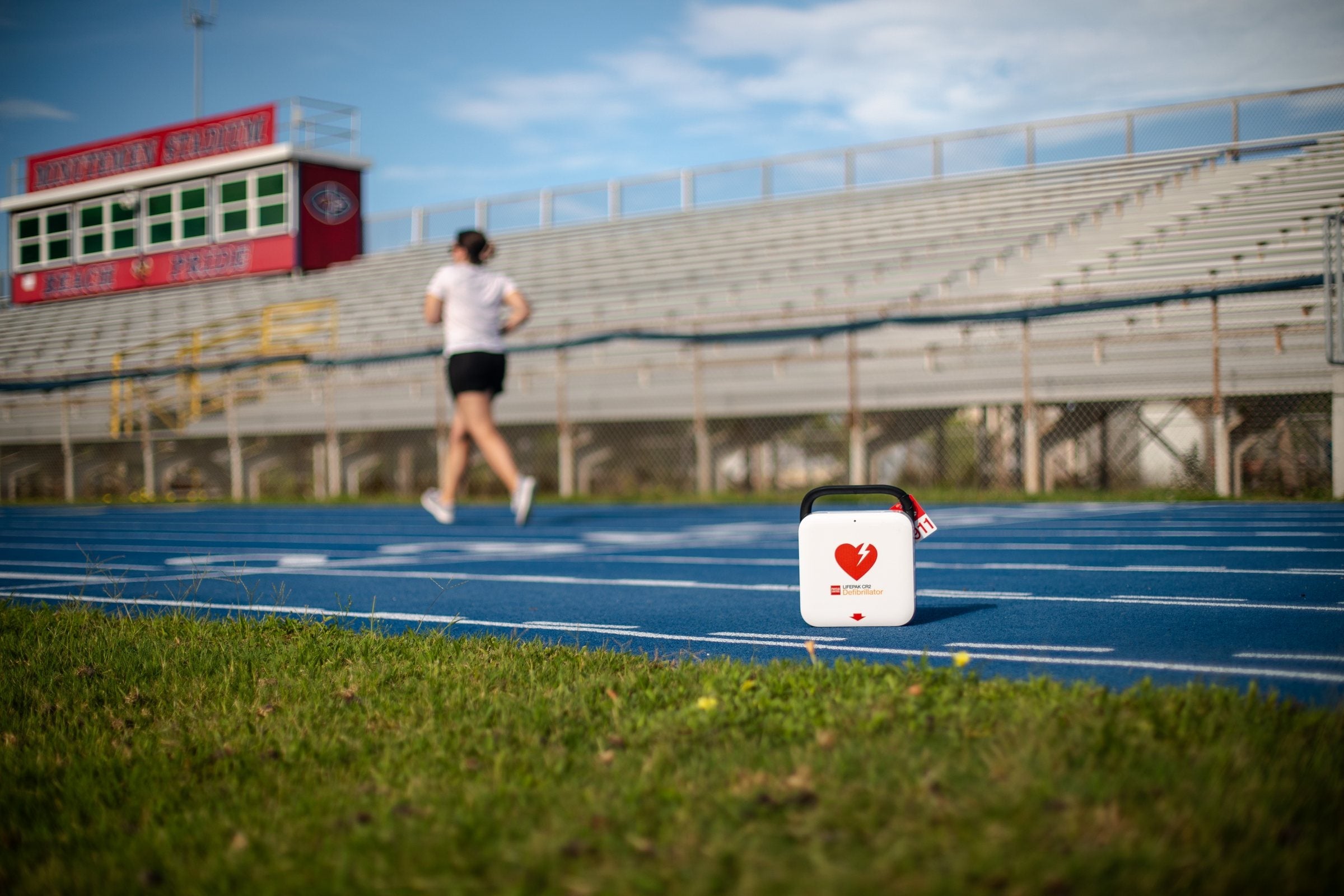 Stryker LIFEPAK CR2 AED positioned beside an athletics track