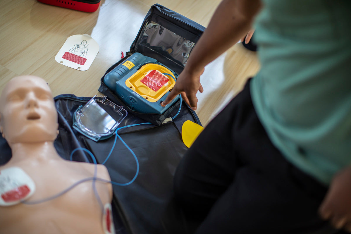 Hands-on First Aid and CPR/AED practice with a training manikin