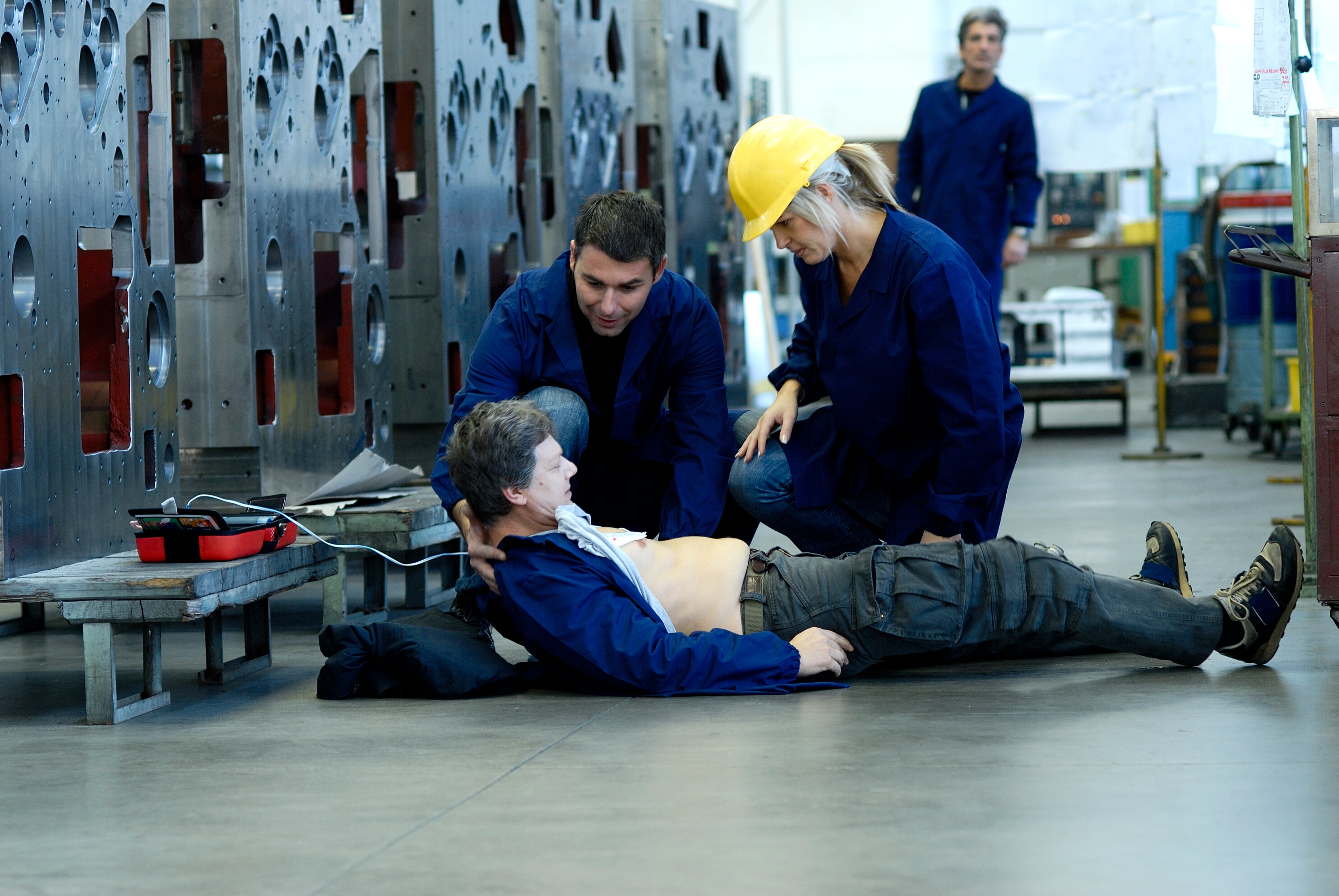 Industrial emergency response scene supported by rugged AED equipment