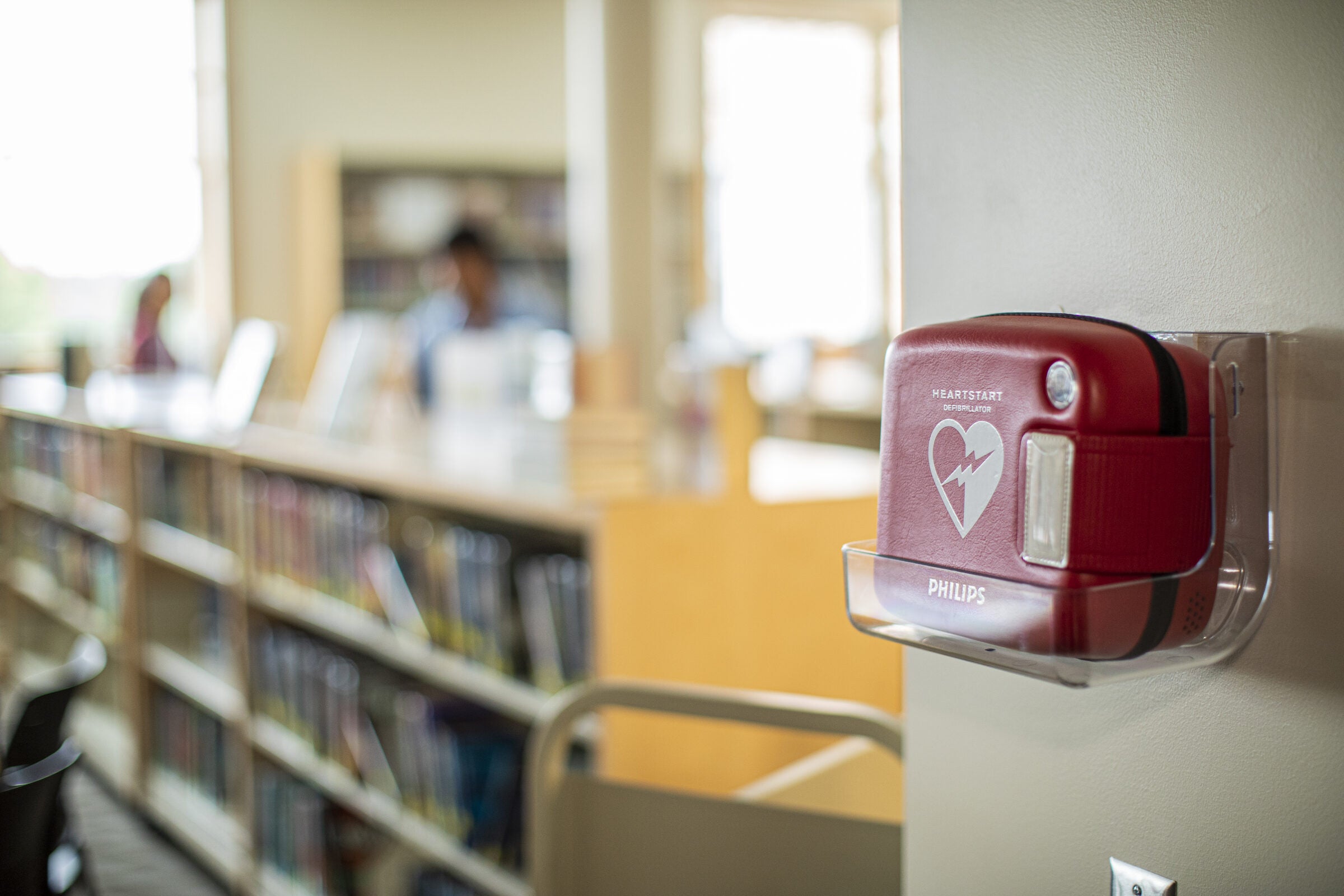 Philips AED installed and visible in a school-access corridor